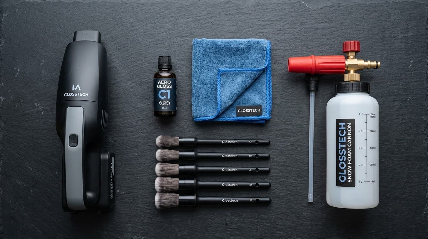 Car detailing flat-lay — handheld vacuum, ceramic coating, brush set, foam cannon